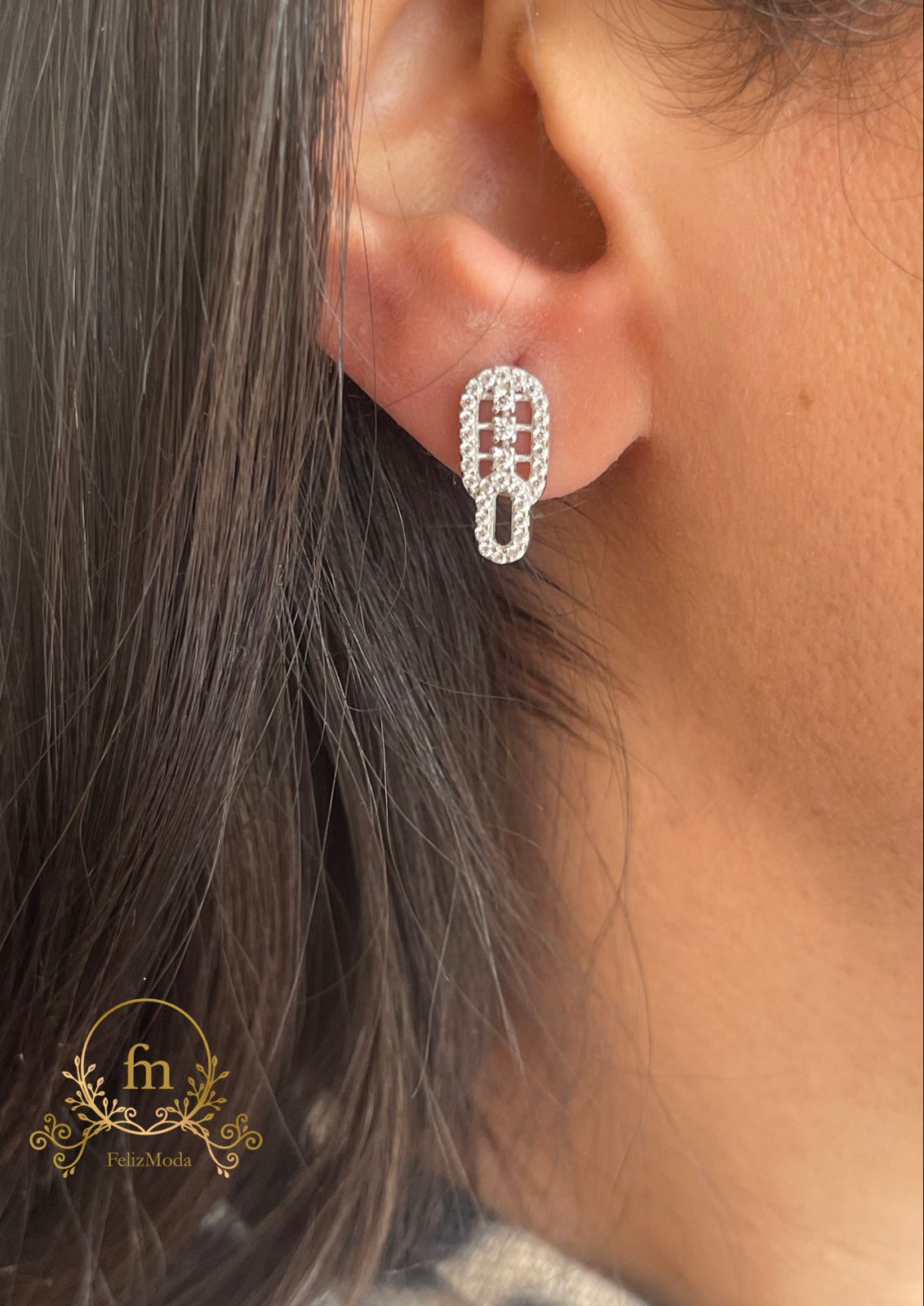 Two connected oval silver earrings with three stones